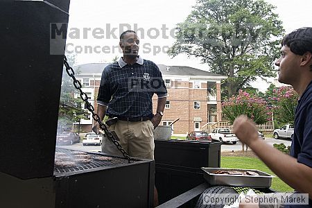 Coach Paul Hewitt and Jimmy Mitchell grill hamburgers at AXO Thursday night.  AXO was the winning sorority for the basketball attendance competition.

Filename: crw_0046_std.jpg
Aperture: f/6.3
Shutter Speed: 1/80
Body: Canon EOS DIGITAL REBEL
Lens: Sigma 15-30mm f/3.5-4.5 EX Aspherical DG DF