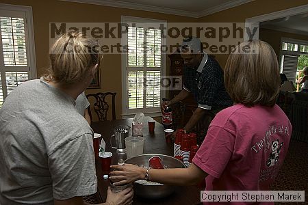 Coach Paul Hewitt pours himself a drink after grilling at AXO Thursday night.  AXO was the winning sorority for the basketball attendance competition.

Filename: crw_0059_std.jpg
Aperture: f/5.0
Shutter Speed: 1/60
Body: Canon EOS DIGITAL REBEL
Lens: Sigma 15-30mm f/3.5-4.5 EX Aspherical DG DF