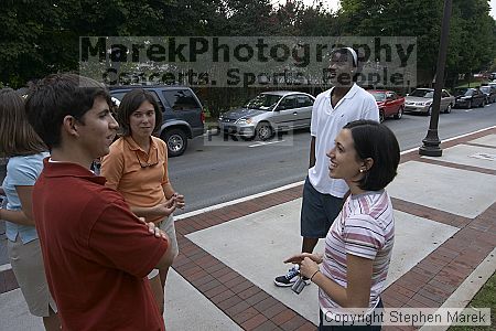 Suzannah Gill, Casey Taylor and Clarence Moore have a conversation after Coach Hewitt's cookout at AXO.  AXO was the winning sorority for the basketball attendance competition.

Filename: crw_0096_std.jpg
Aperture: f/6.3
Shutter Speed: 1/80
Body: Canon EOS DIGITAL REBEL
Lens: Sigma 15-30mm f/3.5-4.5 EX Aspherical DG DF