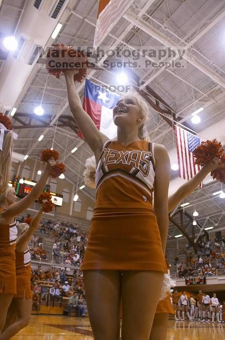 Lacy Rudd cheers for UT at a volleyball game.  The University of Texas women's volleyball team defeated Oklahoma State University (OSU) 3-2 on Saturday, October 21, 2006.

Filename: SRM_20061021_1949263.jpg
Aperture: f/5.0
Shutter Speed: 1/160
Body: Canon EOS DIGITAL REBEL
Lens: Canon EF-S 18-55mm f/3.5-5.6