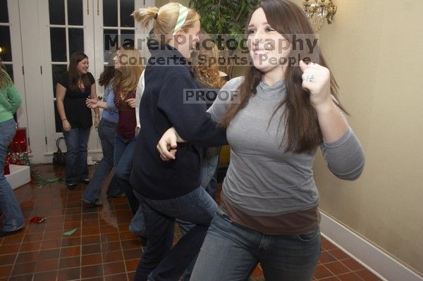 Rachel Hernandez doing the chicken dance at the Alpha Delta Pi Christmas party, Sunday, December 10, 2006.

Filename: SRM_20061210_1818305.jpg
Aperture: f/5.0
Shutter Speed: 1/100
Body: Canon EOS 20D
Lens: Canon EF-S 18-55mm f/3.5-5.6