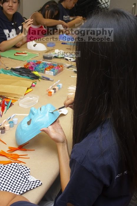 Jenny Hsu decorates a mask at a domestic violence expressive arts workshop for survivors and friends of survivors of domestic and relationship violence.

Filename: SRM_20061023_1729469.jpg
Aperture: f/5.6
Shutter Speed: 1/100
Body: Canon EOS 20D
Lens: Canon EF-S 18-55mm f/3.5-5.6