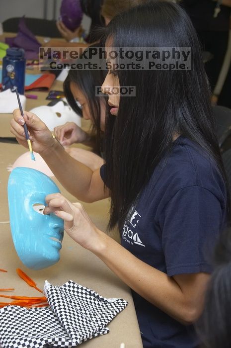Jenny Hsu decorates a mask at a domestic violence expressive arts workshop for survivors and friends of survivors of domestic and relationship violence.

Filename: SRM_20061023_1730402.jpg
Aperture: f/5.6
Shutter Speed: 1/100
Body: Canon EOS 20D
Lens: Canon EF-S 18-55mm f/3.5-5.6