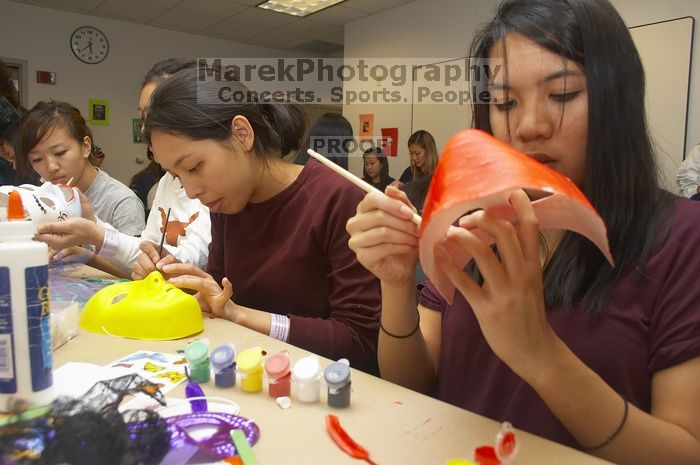 Emily Ng, right, decorates her mask next to Vivian Mai-Tran, left, at a domestic violence expressive arts workshop for survivors and friends of survivors of domestic and relationship violence.

Filename: SRM_20061023_1740129.jpg
Aperture: f/5.6
Shutter Speed: 1/100
Body: Canon EOS 20D
Lens: Canon EF-S 18-55mm f/3.5-5.6