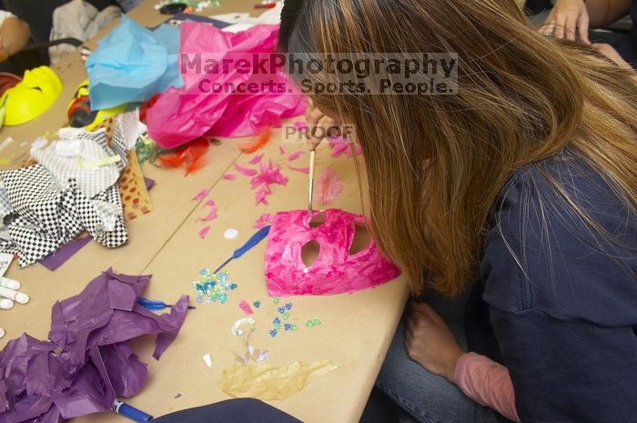 Sharon Kim decorates her mask at a domestic violence expressive arts workshop for survivors and friends of survivors of domestic and relationship violence.

Filename: SRM_20061023_1756520.jpg
Aperture: f/5.6
Shutter Speed: 1/100
Body: Canon EOS 20D
Lens: Canon EF-S 18-55mm f/3.5-5.6