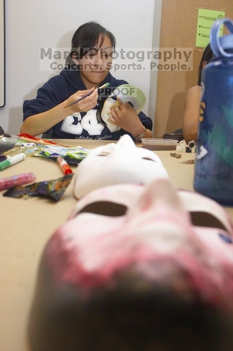 Stephanie Luu, with Hannah Jones' mask in the foreground.  Domestic violence expressive arts workshop for survivors and friends of survivors of domestic and relationship violence.

Filename: SRM_20061023_1800526.jpg
Aperture: f/5.6
Shutter Speed: 1/100
Body: Canon EOS 20D
Lens: Canon EF-S 18-55mm f/3.5-5.6