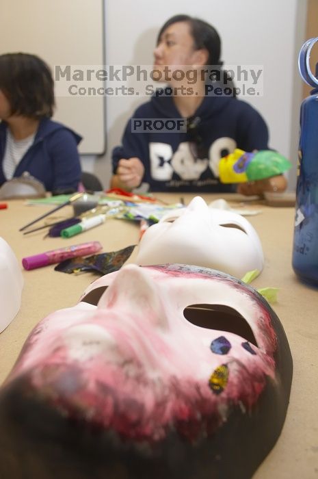 Stephanie Luu, with Hannah Jones' mask in the foreground.  Domestic violence expressive arts workshop for survivors and friends of survivors of domestic and relationship violence.

Filename: SRM_20061023_1801060.jpg
Aperture: f/5.6
Shutter Speed: 1/100
Body: Canon EOS 20D
Lens: Canon EF-S 18-55mm f/3.5-5.6