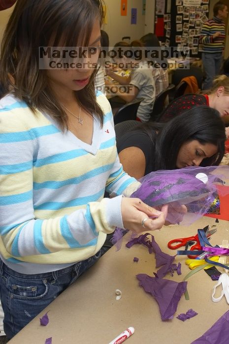 Mae Cortes decorates her mask at a domestic violence expressive arts workshop for survivors and friends of survivors of domestic and relationship violence.

Filename: SRM_20061023_1803366.jpg
Aperture: f/5.6
Shutter Speed: 1/100
Body: Canon EOS 20D
Lens: Canon EF-S 18-55mm f/3.5-5.6