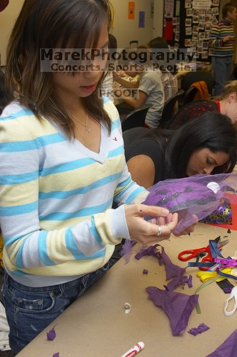 Mae Cortes decorates her mask at a domestic violence expressive arts workshop for survivors and friends of survivors of domestic and relationship violence.

Filename: SRM_20061023_1803387.jpg
Aperture: f/5.6
Shutter Speed: 1/100
Body: Canon EOS 20D
Lens: Canon EF-S 18-55mm f/3.5-5.6