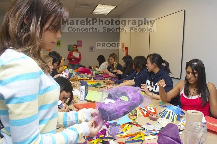 Mae Cortes decorates her mask at a domestic violence expressive arts workshop for survivors and friends of survivors of domestic and relationship violence.

Filename: SRM_20061023_1803569.jpg
Aperture: f/5.6
Shutter Speed: 1/100
Body: Canon EOS 20D
Lens: Canon EF-S 18-55mm f/3.5-5.6