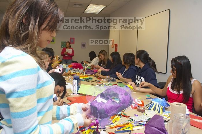 Mae Cortes decorates her mask at a domestic violence expressive arts workshop for survivors and friends of survivors of domestic and relationship violence.

Filename: SRM_20061023_1803580.jpg
Aperture: f/5.6
Shutter Speed: 1/100
Body: Canon EOS 20D
Lens: Canon EF-S 18-55mm f/3.5-5.6