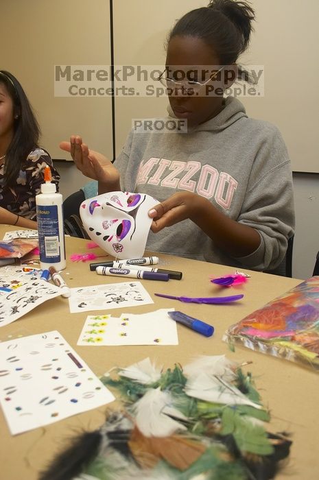 Vimbai Madzura decorates a mask to express herself at a domestic violence expressive arts workshop for survivors and friends of survivors of domestic and relationship violence.

Filename: SRM_20061023_1809002.jpg
Aperture: f/5.6
Shutter Speed: 1/100
Body: Canon EOS 20D
Lens: Canon EF-S 18-55mm f/3.5-5.6