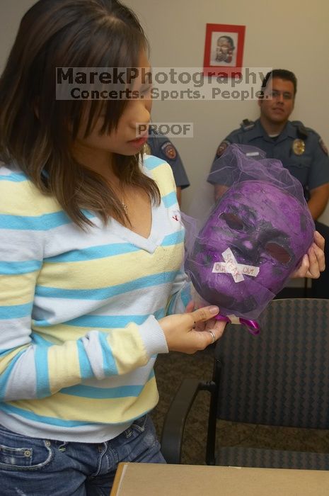 Mae Cortes describes her mask at a domestic violence expressive arts workshop for survivors and friends of survivors of domestic and relationship violence.

Filename: SRM_20061023_1824287.jpg
Aperture: f/5.6
Shutter Speed: 1/100
Body: Canon EOS 20D
Lens: Canon EF-S 18-55mm f/3.5-5.6