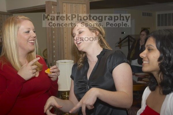 Wendy Howard, center,  and Alina Rizbia, right, at the Alpha Xi Delta Christmas dinner, Friday, December 4, 2006.

Filename: SRM_20061204_1736047.jpg
Aperture: f/5.0
Shutter Speed: 1/250
Body: Canon EOS 20D
Lens: Canon EF-S 18-55mm f/3.5-5.6