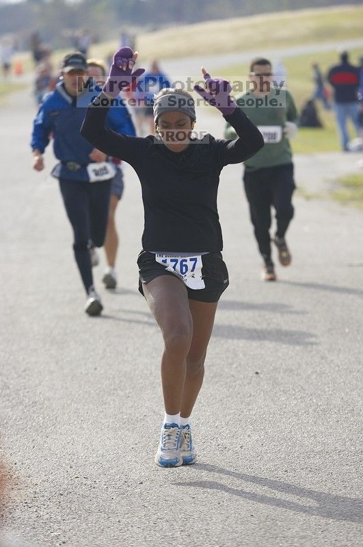 Venus Dever, 1:40:07, dancing across the finish at Decker Challenge 20K 2006 road race.

Filename: SRM_20061203_0944043.jpg
Aperture: f/4.0
Shutter Speed: 1/800
Body: Canon EOS-1D Mark II
Lens: Canon EF 80-200mm f/2.8 L