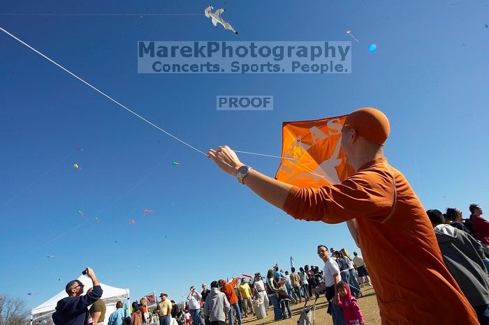 Chris Lam attempts to fly his UT kite at the 79th annual Zilker Park Kite Festival, Sunday, March 4, 2007.

Filename: SRM_20070304_1531562.jpg
Aperture: f/11.0
Shutter Speed: 1/250
Body: Canon EOS-1D Mark II
Lens: Sigma 15-30mm f/3.5-4.5 EX Aspherical DG DF