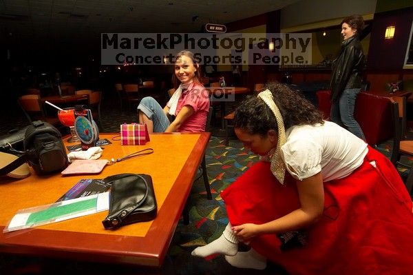Jessica Schreyer and Sabrina Garza (right) lace up for bowling.  Alpha Xi Delta held a sock hop themed date night at the Austin 300 bowling alley, Thursday night, March 29, 2007.

Filename: SRM_20070329_2019128.jpg
Aperture: f/8.0
Shutter Speed: 1/200
Body: Canon EOS-1D Mark II
Lens: Sigma 15-30mm f/3.5-4.5 EX Aspherical DG DF