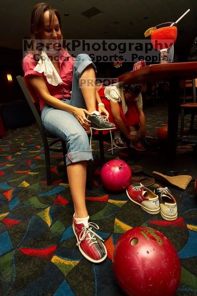 Jessica Schreyer laces up for bowling.  Alpha Xi Delta held a sock hop themed date night at the Austin 300 bowling alley, Thursday night, March 29, 2007.

Filename: SRM_20070329_2019409.jpg
Aperture: f/8.0
Shutter Speed: 1/200
Body: Canon EOS-1D Mark II
Lens: Sigma 15-30mm f/3.5-4.5 EX Aspherical DG DF