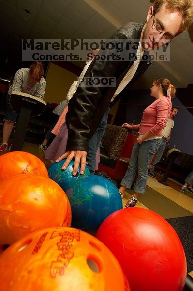 Blake Lindell reaches for a bowling ball.  Alpha Xi Delta held a sock hop themed date night at the Austin 300 bowling alley, Thursday night, March 29, 2007.

Filename: SRM_20070329_2036180.jpg
Aperture: f/8.0
Shutter Speed: 1/200
Body: Canon EOS-1D Mark II
Lens: Sigma 15-30mm f/3.5-4.5 EX Aspherical DG DF