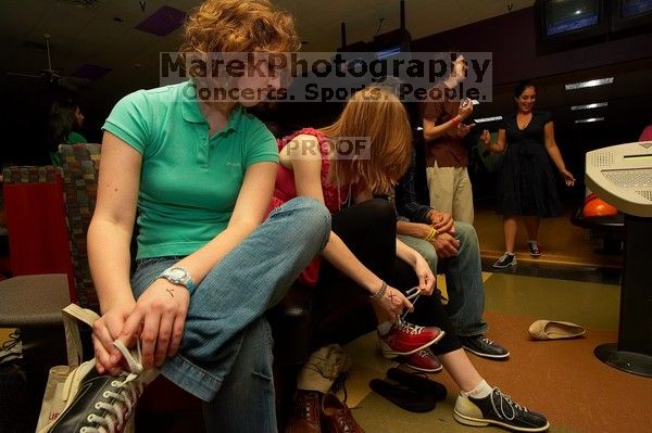 Brooke Garvey (left) and Kristen Ellefson tying their shoes before bowling.  Alpha Xi Delta held a sock hop themed date night at the Austin 300 bowling alley, Thursday night, March 29, 2007.

Filename: SRM_20070329_2038182.jpg
Aperture: f/8.0
Shutter Speed: 1/200
Body: Canon EOS-1D Mark II
Lens: Sigma 15-30mm f/3.5-4.5 EX Aspherical DG DF