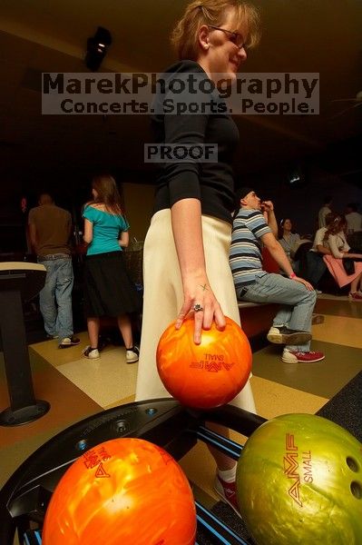 Heidi Frank reaching for a bowling ball.  Alpha Xi Delta held a sock hop themed date night at the Austin 300 bowling alley, Thursday night, March 29, 2007.

Filename: SRM_20070329_2100329.jpg
Aperture: f/8.0
Shutter Speed: 1/200
Body: Canon EOS-1D Mark II
Lens: Sigma 15-30mm f/3.5-4.5 EX Aspherical DG DF