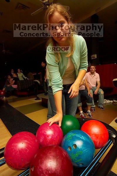 Alice Aertker reaching for a bowling ball.  Alpha Xi Delta held a sock hop themed date night at the Austin 300 bowling alley, Thursday night, March 29, 2007.

Filename: SRM_20070329_2103187.jpg
Aperture: f/8.0
Shutter Speed: 1/200
Body: Canon EOS-1D Mark II
Lens: Sigma 15-30mm f/3.5-4.5 EX Aspherical DG DF