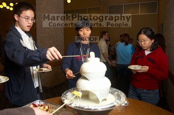 Angela Fung and Arlena Yu.  The Asian Business Students Association (ABSA) hosted a chocolate fondue Friday, January 26, 2007 before heading off to a movie premier.

Filename: SRM_20070126_1617420.jpg
Aperture: f/4.5
Shutter Speed: 1/160
Body: Canon EOS 20D
Lens: Canon EF-S 18-55mm f/3.5-5.6