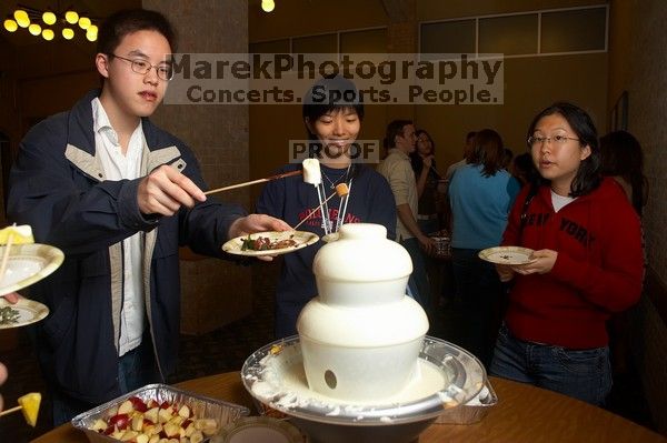 Angela Fung and Arlena Yu.  The Asian Business Students Association (ABSA) hosted a chocolate fondue Friday, January 26, 2007 before heading off to a movie premier.

Filename: SRM_20070126_1617441.jpg
Aperture: f/4.5
Shutter Speed: 1/160
Body: Canon EOS 20D
Lens: Canon EF-S 18-55mm f/3.5-5.6