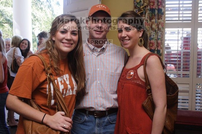 Sisters Allison and Mary Stewart Anderson, both Kappas, with their father.  Kappa Kappa Gamma (KKG) hosted a parents' weekend barbecue before the UT vs Nebraska football game on Saturday, October 27, 2007 at their sorority house.

Filename: SRM_20071027_1239063.jpg
Aperture: f/8.0
Shutter Speed: 1/30
Body: Canon EOS 20D
Lens: Canon EF-S 18-55mm f/3.5-5.6