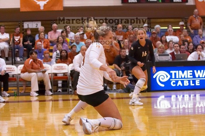 UT sophomore Heather Kisner (#19, DS) hits the ball as UT senior Alyson Jennings (#16, L) watches.  The Longhorns defeated the Huskers 3-0 on Wednesday night, October 24, 2007 at Gregory Gym.

Filename: SRM_20071024_1844187.jpg
Aperture: f/4.0
Shutter Speed: 1/400
Body: Canon EOS-1D Mark II
Lens: Canon EF 80-200mm f/2.8 L