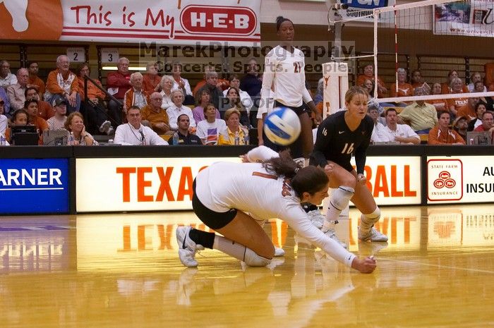 UT freshman Juliann Faucette (#1, OH) misses the ball as UT senior Alyson Jennings (#16, L) and UT sophomore Destinee Hooker (#21, OH) watch.  The Longhorns defeated the Huskers 3-0 on Wednesday night, October 24, 2007 at Gregory Gym.

Filename: SRM_20071024_1901568.jpg
Aperture: f/4.0
Shutter Speed: 1/400
Body: Canon EOS-1D Mark II
Lens: Canon EF 80-200mm f/2.8 L