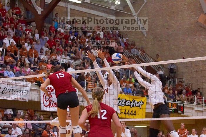 UT senior Brandy Magee (#44, MB) and UT sophomore Destinee Hooker (#21, OH) attempt to block a spike from Nebraska sophomore Kori Cooper (#15, MB) as Nebraska sophomore Rachel Holloway (#12, S) watches.  The Longhorns defeated the Huskers 3-0 on Wednesday

Filename: SRM_20071024_1910149.jpg
Aperture: f/4.0
Shutter Speed: 1/400
Body: Canon EOS-1D Mark II
Lens: Canon EF 80-200mm f/2.8 L
