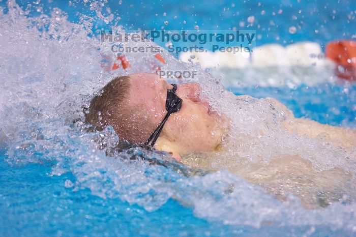 UT senior Matthew McGinnis took first in the 200 yard backstroke with a time of 1:47.37.  The University of Texas Longhorns defeated The University of Georgia Bulldogs 157-135 on Saturday, January 12, 2008.

Filename: SRM_20080112_1158481.jpg
Aperture: f/2.8
Shutter Speed: 1/400
Body: Canon EOS-1D Mark II
Lens: Canon EF 300mm f/2.8 L IS