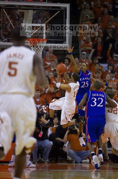 UT sophomore D.J. Augustin (#14, G) shoots over KU senior Russell Robinson (#3, Guard) and KU junior Brandon Rush (#25, Guard).  The University of Texas (UT) Longhorns defeated the University of Kansas Jayhawks 72-69 in Austin, Texas on Monday, February 11, 2008.

Filename: SRM_20080211_2012421.jpg
Aperture: f/2.8
Shutter Speed: 1/640
Body: Canon EOS-1D Mark II
Lens: Canon EF 80-200mm f/2.8 L