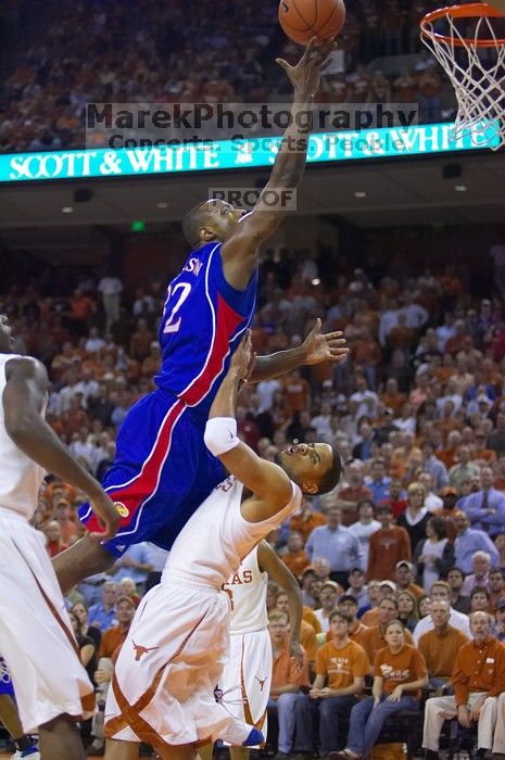 KU senior Darnell Jackson (#32, Forward) goes in for a layup over UT sophomore D.J. Augustin (#14, G).  The University of Texas (UT) Longhorns defeated the University of Kansas Jayhawks 72-69 in Austin, Texas on Monday, February 11, 2008.

Filename: SRM_20080211_2015166.jpg
Aperture: f/2.8
Shutter Speed: 1/640
Body: Canon EOS-1D Mark II
Lens: Canon EF 80-200mm f/2.8 L