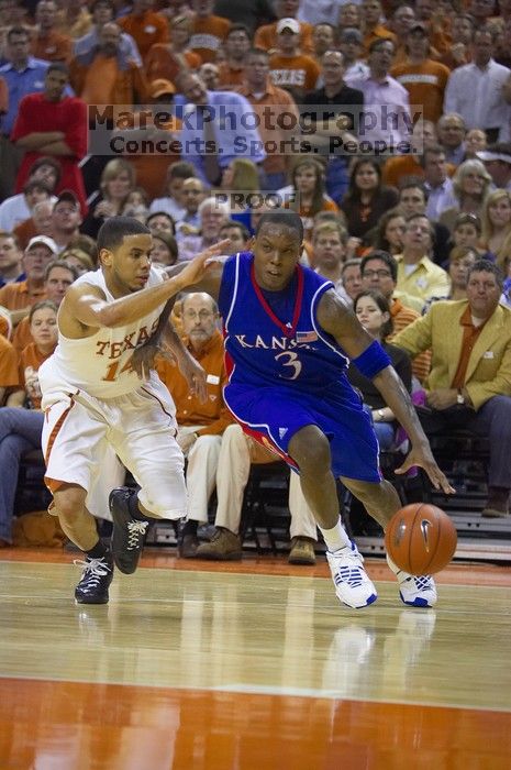 UT sophomore D.J. Augustin (#14, G) defends KU senior Russell Robinson (#3, Guard).  The University of Texas (UT) Longhorns defeated the University of Kansas Jayhawks 72-69 in Austin, Texas on Monday, February 11, 2008.

Filename: SRM_20080211_2040444.jpg
Aperture: f/2.8
Shutter Speed: 1/640
Body: Canon EOS-1D Mark II
Lens: Canon EF 80-200mm f/2.8 L