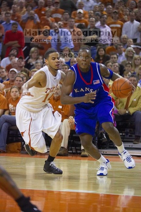 UT sophomore D.J. Augustin (#14, G) defends KU senior Russell Robinson (#3, Guard).  The University of Texas (UT) Longhorns defeated the University of Kansas Jayhawks 72-69 in Austin, Texas on Monday, February 11, 2008.

Filename: SRM_20080211_2040466.jpg
Aperture: f/2.8
Shutter Speed: 1/640
Body: Canon EOS-1D Mark II
Lens: Canon EF 80-200mm f/2.8 L