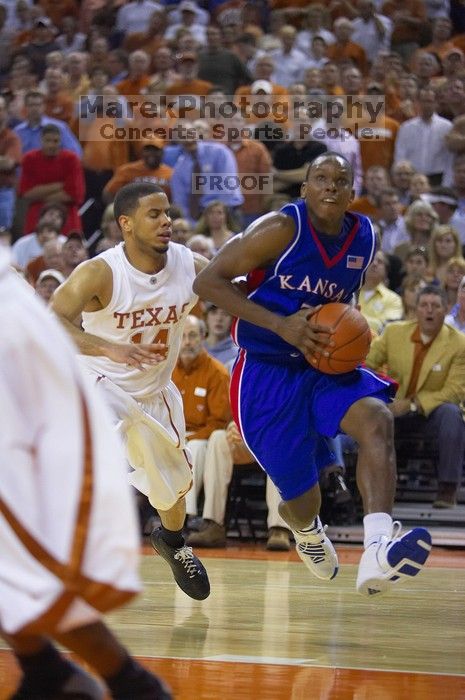 UT sophomore D.J. Augustin (#14, G) defends KU senior Russell Robinson (#3, Guard).  The University of Texas (UT) Longhorns defeated the University of Kansas Jayhawks 72-69 in Austin, Texas on Monday, February 11, 2008.

Filename: SRM_20080211_2040487.jpg
Aperture: f/2.8
Shutter Speed: 1/640
Body: Canon EOS-1D Mark II
Lens: Canon EF 80-200mm f/2.8 L