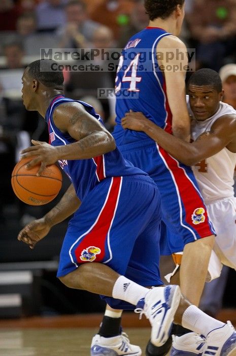 UT sophomore Justin Mason (#24, G) gets picked off by KU senior Sasha Kaun (#24, Center).  The University of Texas (UT) Longhorns defeated the University of Kansas Jayhawks 72-69 in Austin, Texas on Monday, February 11, 2008.

Filename: SRM_20080211_2124528.jpg
Aperture: f/2.8
Shutter Speed: 1/640
Body: Canon EOS 20D
Lens: Canon EF 300mm f/2.8 L IS