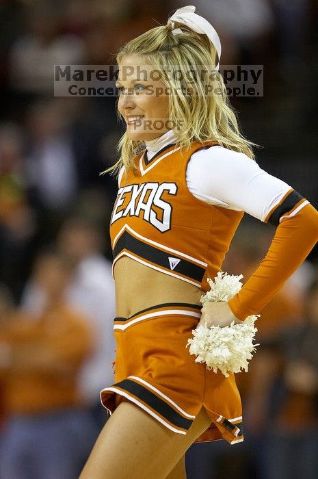 Texas cheerleader.  The University of Texas (UT) Longhorns defeated the University of Kansas Jayhawks 72-69 in Austin, Texas on Monday, February 11, 2008.

Filename: SRM_20080211_2148562.jpg
Aperture: f/2.8
Shutter Speed: 1/640
Body: Canon EOS 20D
Lens: Canon EF 300mm f/2.8 L IS