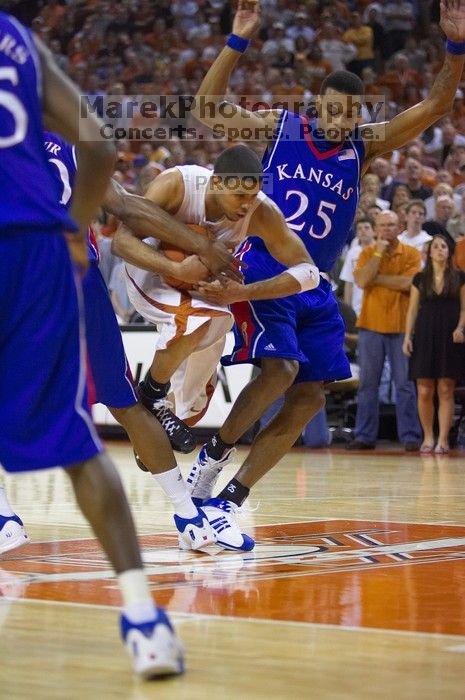 UT sophomore D.J. Augustin (#14, G) drives past KU junior Brandon Rush (#25, Guard) in the Kansas basketball game.  The University of Texas (UT) Longhorns defeated the University of Kansas Jayhawks 72-69 in Austin, Texas on Monday, February 11, 2008.

Filename: SRM_20080211_2159160.jpg
Aperture: f/2.8
Shutter Speed: 1/640
Body: Canon EOS-1D Mark II
Lens: Canon EF 80-200mm f/2.8 L