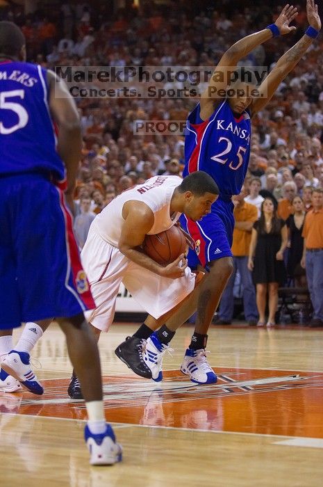 UT sophomore D.J. Augustin (#14, G) drives past KU junior Brandon Rush (#25, Guard) in the Kansas basketball game.  The University of Texas (UT) Longhorns defeated the University of Kansas Jayhawks 72-69 in Austin, Texas on Monday, February 11, 2008.

Filename: SRM_20080211_2159182.jpg
Aperture: f/2.8
Shutter Speed: 1/640
Body: Canon EOS-1D Mark II
Lens: Canon EF 80-200mm f/2.8 L