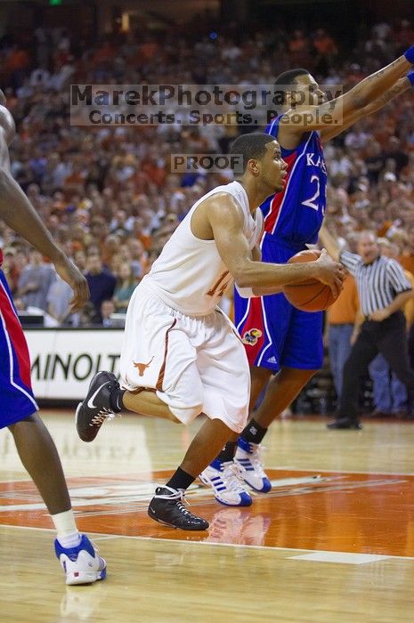 UT sophomore D.J. Augustin (#14, G) drives past KU junior Brandon Rush (#25, Guard) in the Kansas basketball game.  The University of Texas (UT) Longhorns defeated the University of Kansas Jayhawks 72-69 in Austin, Texas on Monday, February 11, 2008.

Filename: SRM_20080211_2159224.jpg
Aperture: f/2.8
Shutter Speed: 1/640
Body: Canon EOS-1D Mark II
Lens: Canon EF 80-200mm f/2.8 L