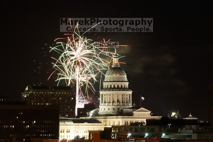 Austin Independence Day fireworks with the Capitol building, as viewed from atop the Manor Garage at The University of Texas at Austin.  The fireworks were launched from Auditorium Shores, downtown Austin, Friday, July 4, 2008.

Filename: SRM_20080704_2134365.jpg
Aperture: f/11.0
Shutter Speed: 10/1
Body: Canon EOS 20D
Lens: Canon EF 80-200mm f/2.8 L