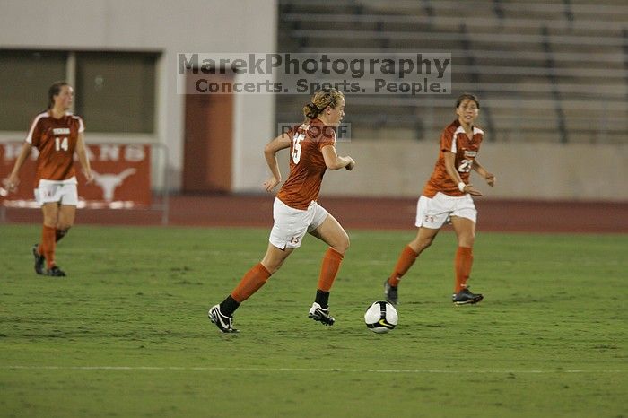 UT freshman Kylie Doniak (#15, Midfielder) takes the ball downfield as UT senior Kasey Moore (#14, Defender) and UT senior Courtney Gaines (#23, Midfielder) watch.  The University of Texas women's soccer team tied 0-0 against the Texas A&M Aggies Friday night, September 27, 2008.

Filename: SRM_20080926_1934144.jpg
Aperture: f/4.0
Shutter Speed: 1/400
Body: Canon EOS-1D Mark II
Lens: Canon EF 300mm f/2.8 L IS