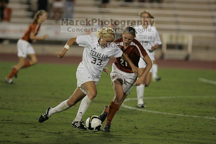 UT junior Emily Anderson (#21, Forward) plays defense on A&M #33.  The University of Texas women's soccer team tied 0-0 against the Texas A&M Aggies Friday night, September 27, 2008.

Filename: SRM_20080926_2027422.jpg
Aperture: f/2.8
Shutter Speed: 1/640
Body: Canon EOS-1D Mark II
Lens: Canon EF 300mm f/2.8 L IS