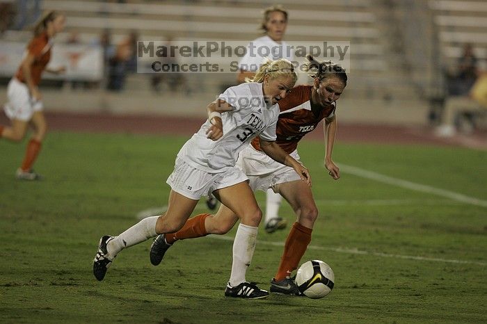 UT junior Emily Anderson (#21, Forward) plays defense on A&M #33.  The University of Texas women's soccer team tied 0-0 against the Texas A&M Aggies Friday night, September 27, 2008.

Filename: SRM_20080926_2027424.jpg
Aperture: f/2.8
Shutter Speed: 1/640
Body: Canon EOS-1D Mark II
Lens: Canon EF 300mm f/2.8 L IS