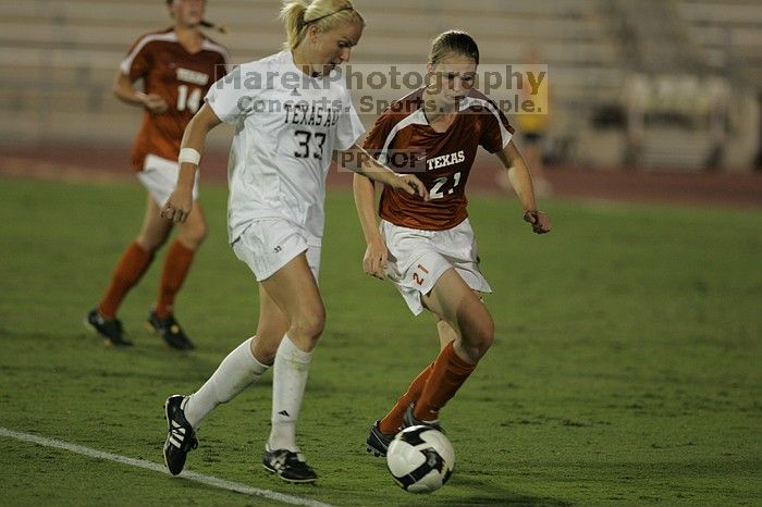 UT junior Emily Anderson (#21, Forward) plays defense on A&M #33.  The University of Texas women's soccer team tied 0-0 against the Texas A&M Aggies Friday night, September 27, 2008.

Filename: SRM_20080926_2027440.jpg
Aperture: f/2.8
Shutter Speed: 1/640
Body: Canon EOS-1D Mark II
Lens: Canon EF 300mm f/2.8 L IS