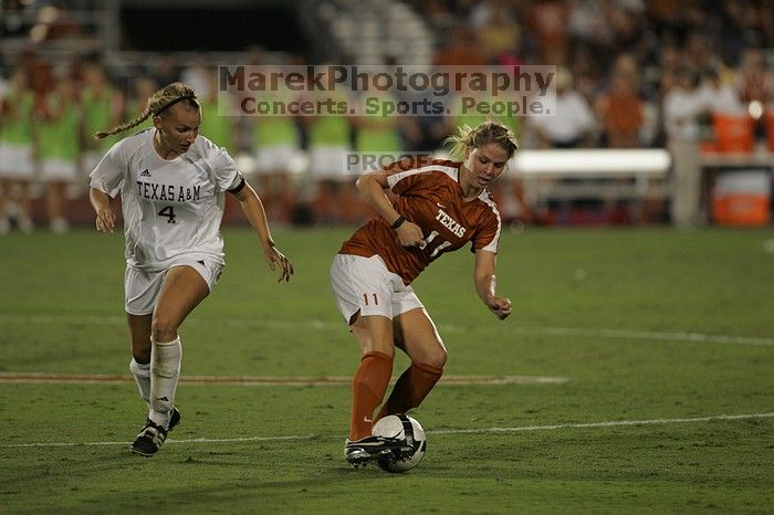 UT sophomore Niki Arlitt (#11, Forward) steals the ball from an Aggie.  The University of Texas women's soccer team tied 0-0 against the Texas A&M Aggies Friday night, September 27, 2008.

Filename: SRM_20080926_2056088.jpg
Aperture: f/2.8
Shutter Speed: 1/640
Body: Canon EOS-1D Mark II
Lens: Canon EF 300mm f/2.8 L IS