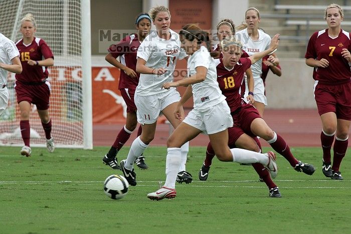 UT sophomore Niki Arlitt (#11, Forward) passes the ball to UT sophomore Alisha Ortiz (#12, Forward).  The University of Texas women's soccer team won 2-1 against the Iowa State Cyclones Sunday afternoon, October 5, 2008.

Filename: SRM_20081005_11594492.jpg
Aperture: f/8.0
Shutter Speed: 1/800
Body: Canon EOS-1D Mark II
Lens: Canon EF 300mm f/2.8 L IS